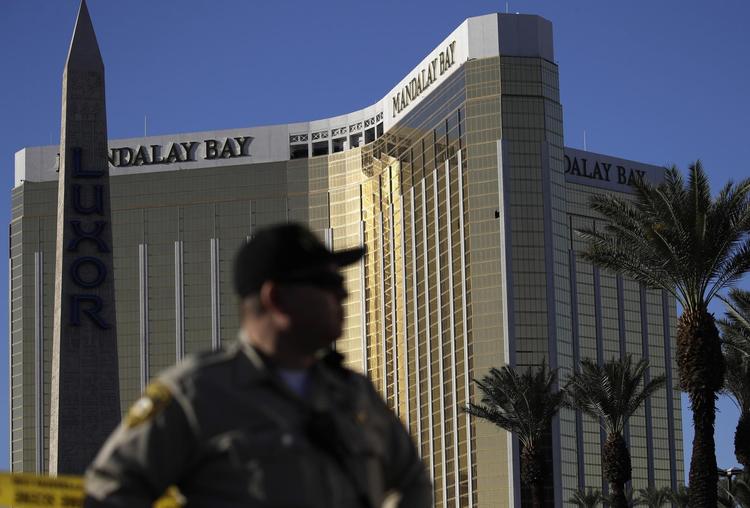 En betjent holder vagt foran Hotel Mandalay Bay i Las Vegas, som oplevede et dødeligt skuddrama sidste år. John Locher/AP